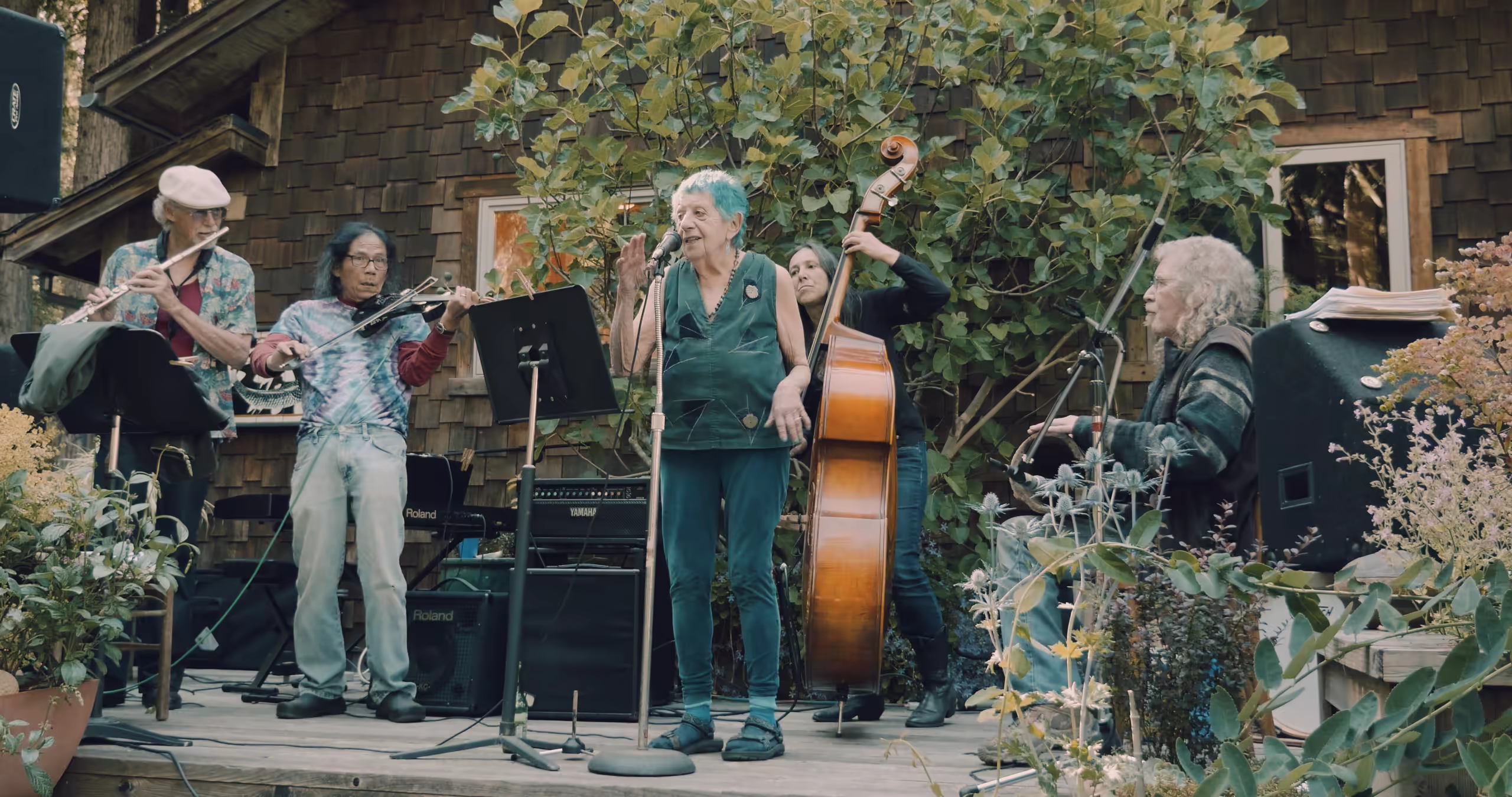 ruth weiss performing outside a house